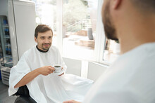 Glad Guy Being Served Coffee At Top Quality Barber Salon