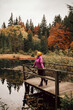 © Andrii Marushchynets - Young traveler hiking girl with backpacks. Hiking in mountains. Sunny landscape. Tourist traveler on background view mockup.