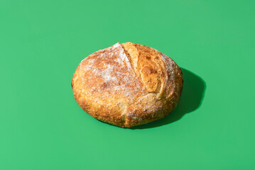 Canvas Print - Homemade white bread minimalist on a green background