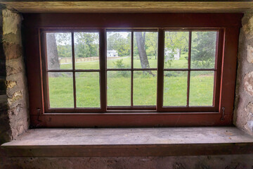 Red windows in stone wall at Hopewell Furnace National Historic Site in Pennsylvania. American 19th century rural 