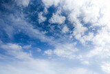 Fototapeta Niebo - Soft and fluffy clouds formation on the bright sunny blue sky. Nature abstract background. Fresh air, weather and freedom concept