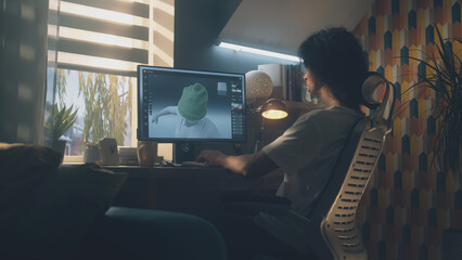 Poster - Guy sitting at the table and designing clothes in 3D modeling professional program on personal computer while working remotely from home