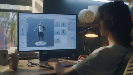 Aufkleber - male young 3d designer having remote work on 3d modeling and designing clothes using pc with profess
