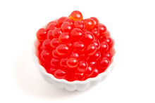 A Bowl Filled With Popping Boba On A White Background