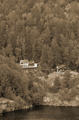 Wall Mural - Typical Swedish nature and houses on the shore of the fjord. View from the high bridge over the fjord. The border of Norway and Sweden.Near the town Selater,Sweden