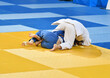 © 0608195706081957 - Fighter girls judoists in kimonos compete on the tatami