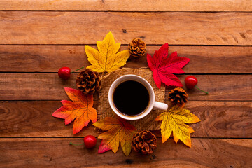 Wall Mural - hot coffee espresso with mable leaf in autumn season arrangement flat lay postcard style on background wooden