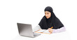 A Muslim girl uses a laptop computer for online learning.