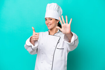 Young caucasian chef woman isolated on blue background counting six with fingers