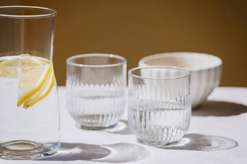 Wall Mural - jug with lemon water and glass on table