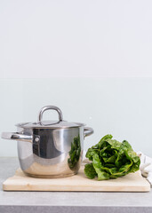 Wall Mural - cooking pot and fresh romaine salad at kitchen