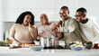 © Alessandro Biascioli - Happy Hispanic family having fun cooking together in modern kitchen - Food and parents unity concept