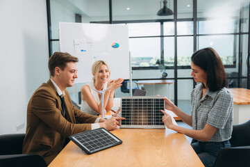 Discussion among businesspeople on the latest developments in solar cell panel technology and Solar Energy Environment Concept.