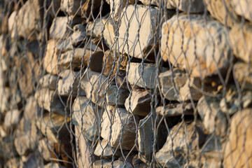 Poster - metal mesh on a stone wall. slope crumbling protection