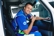 © Peakstock - Emergency medical services worker. Smiling male paramedic talking on portable radio while sitting in ambulance