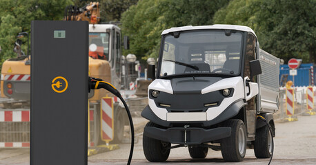 Wall Mural - Urban electric truck with charging station at construction site