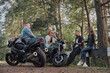 © perfectlab - Meeting A company of friends of motorcyclists bikers on motorcycles stopped on the roadside having fun and drinking tea