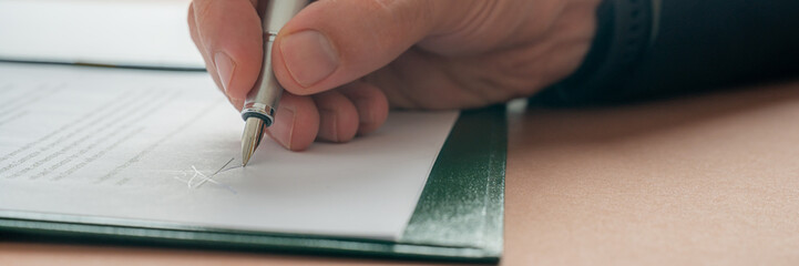 Wall Mural - Caucasian male hand signing a document