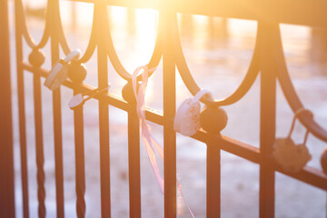 heart-shaped locks hang on the fence on the river embankment as a sign of love and loyalty for a wed