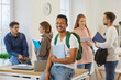 © Studio Romantic - Portrait of smiling millennial ethnic guy student with backpack sit at desk in university classroom. Happy young black biracial male pupil pose in college or school at break. Education concept.