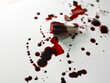 Used red tampon in blood on white and bloody background. Health care, hygiene, feminine concept
