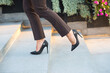 © Solid photos - Long legs and high heels of young businesswoman climbing stairs