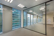 © alhim - pacious office space with light walls, panoramic windows and a glass partition.