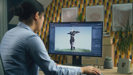 Poster - Asian female 3D designer making animation for video game character using modern computer with software for creating 3D modeling projects