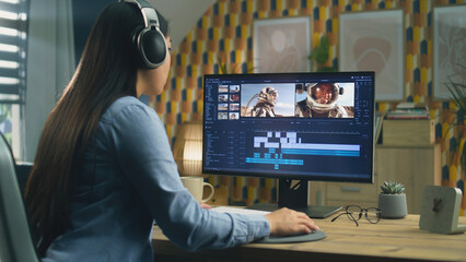 Poster - Woman in headphones editing video with astronauts for blog about space in professional software on computer, while sitting at the table at home and working remotely.
