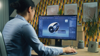Poster - Female 3D designer using pc with professional program and creating 3D prototype of airplane turbine while working remotely at home office