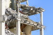 Closeup Reinforced concrete building structure partially demolished as a web structure against a blue sky