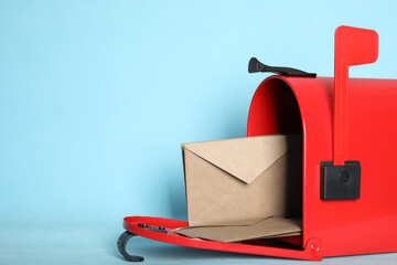 Wall Mural - Open red letter box with envelopes on turquoise background, closeup. Space for text