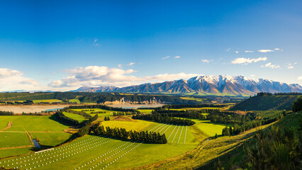 Wall Mural - Near the village of  Windwhistle looking over agricultural farming fields and the Rakaia Gorge towards Mt Hutt with a slight dusting of snow on the mountain peak