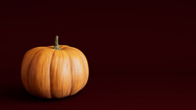 Seasonal Background Image With Copy-space. Pumpkin On Deep Plum Red Color. Fall Concept.