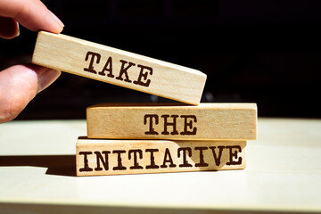 Wall Mural - Wooden blocks with words 'Take the Initiative'.