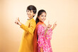 Happy indian kids dancing together wearing traditional or ethnic cloths isolated on studio background, boy and girl children celebrating diwali or baisakhi, festival, online sale 