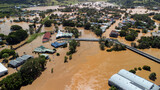 Fototapeta  - Flooded river engulfing buildings and bridges in Lismore NSW Australia 2022