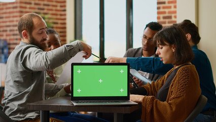 Poster - diverse team of people working with greenscreen on laptop in business office. coworkers using docume