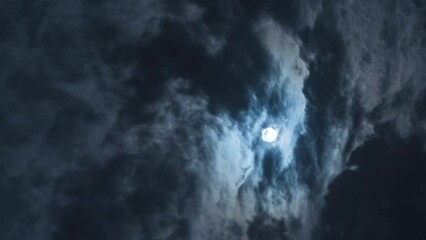 Wall Mural - a dramatic landscape of the night sky. black rays and light clouds sweep across the sky covering the