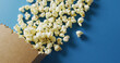 Image of close up of box of popcorn on blue background