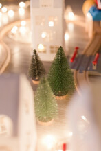 Miniature Christmas Trees By Wooden Toy Train Tracks At Home