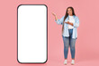© Prostock-studio - Black Lady Showing Huge Smartphone With Empty Screen, Pink Background