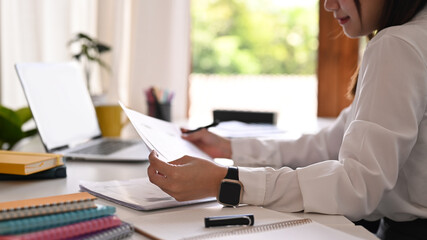 Wall Mural - Cropped shot of young creative woman working on mobile application software design project at modern office