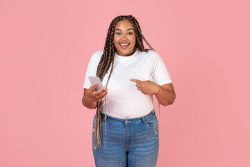 Wall Mural - Happy African American Woman Using Cellphone Standing Over Pink Background