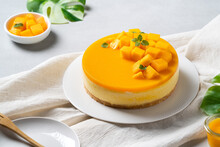 Delicious Glazed Mango No Baked Cheese Cake With Fresh Diced Mango Pulp Topping On Bright Table Background.