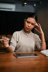 Portrait, Stressed and thoughtful Asian businesswoman working in the office in the late night.