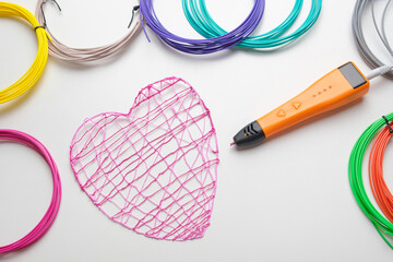 3d Pen. Printing with Colored Plastic Wire Filament. Child making a Christmas Three, Heart shape drawing with 3D pen. Artwork, Robotics. STEAM, STEM education. Modern Technologies. Study at home