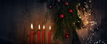 Horizontal Christmas And Advent Background With Four Red Burning Candles And Natural Decoration On Rustic Wood And Space For Text. 