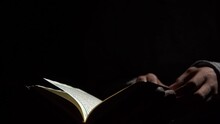 Reading Quran, Reading A Koran, Reading A Holy Quran With Finger. Quranic Reading. Reading A Holy Book. Reading The Holy Qur'an, Reading In Dark, Slowmotion Footage.