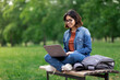 © Prostock-studio - Online Learning. Young Arab Woman With Laptop Sitting On Bench In Park